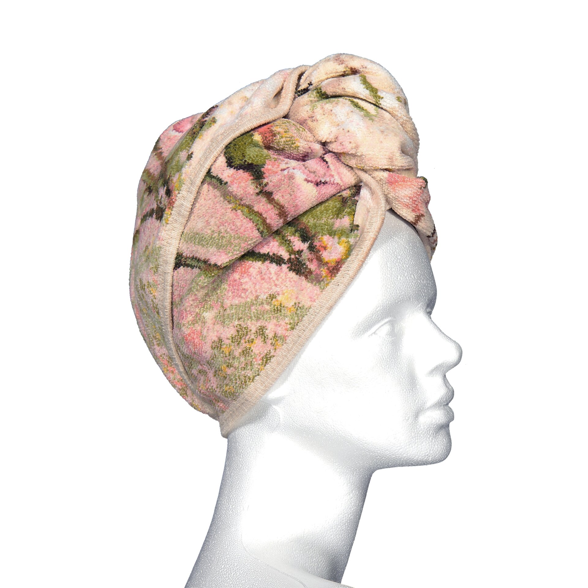 Model in floral patterned head wrap, adult woman.