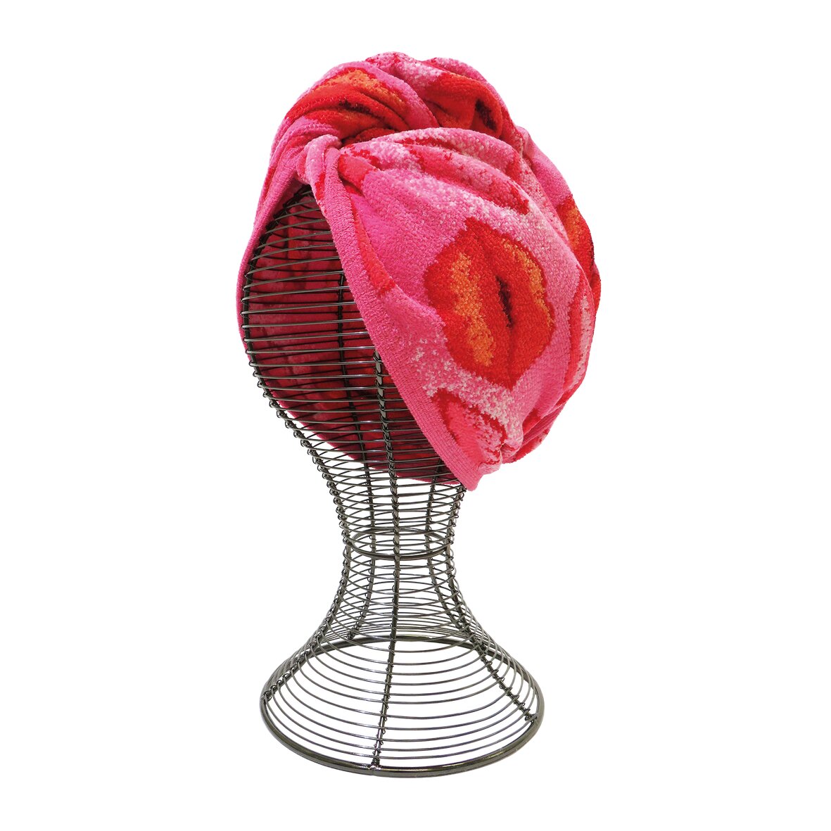 Red and pink floral patterned textile draped over metal wire mannequin head.