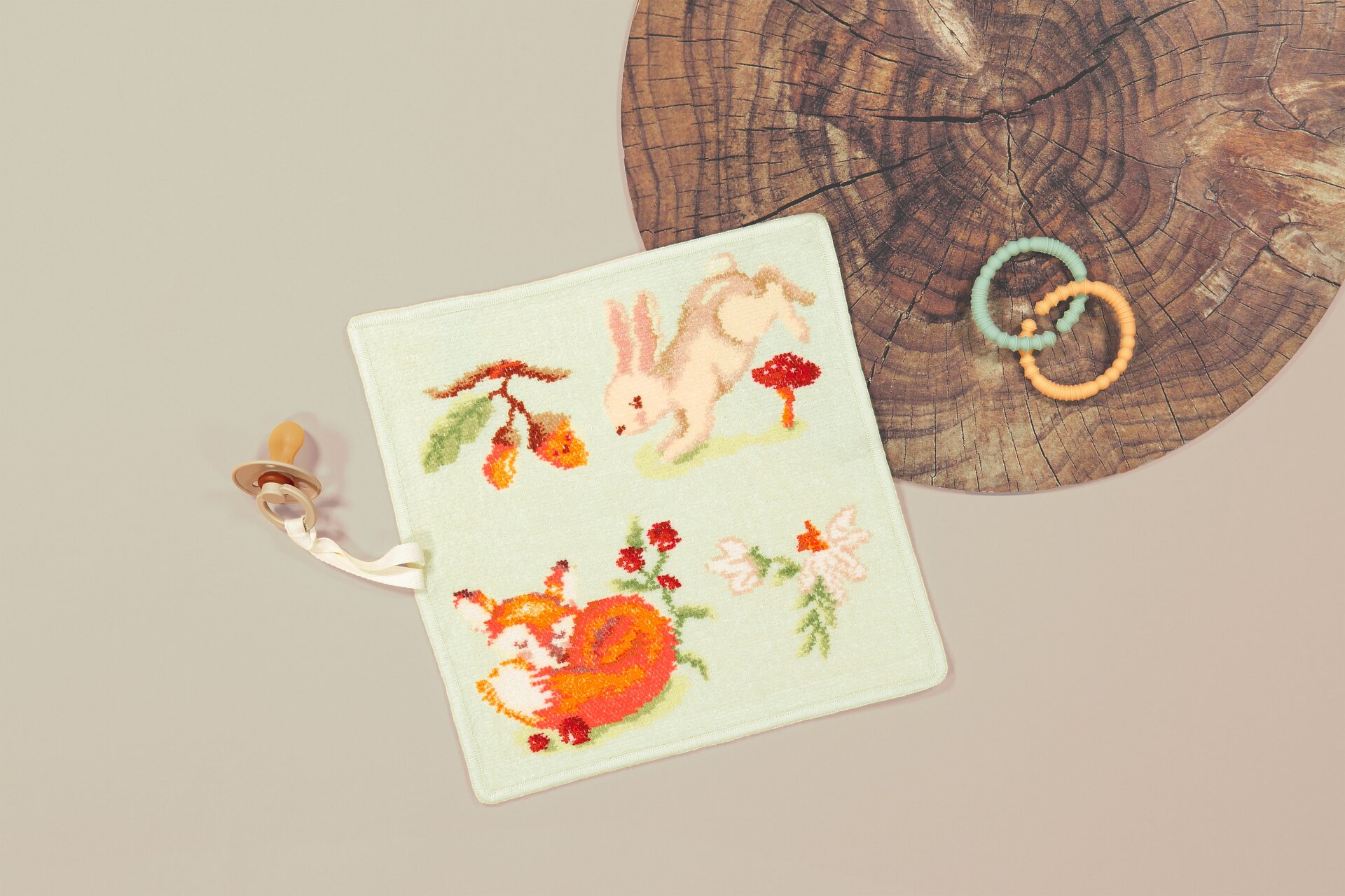 FEILER FOREST TALES Chenille product shown in a lifestyle setting with teething ring.