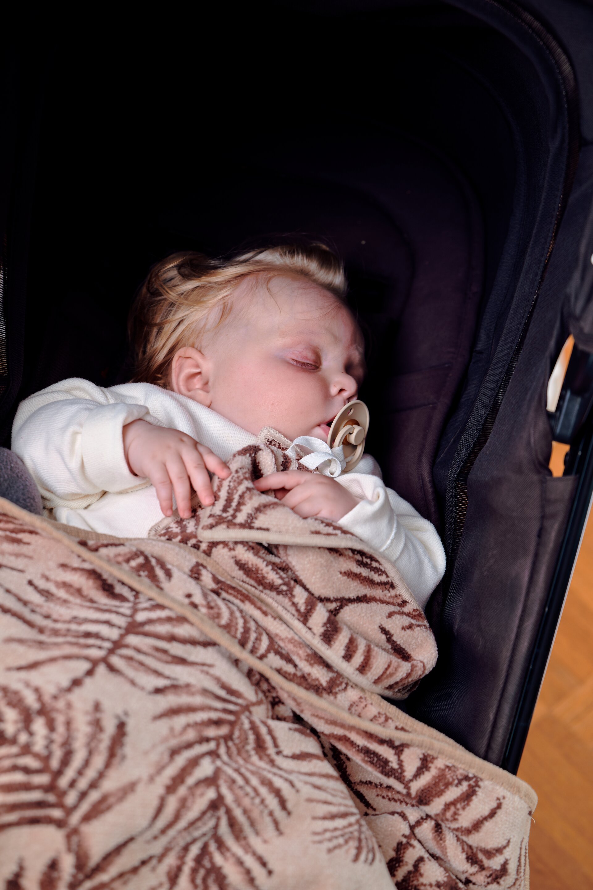 FEILER DESERT PALMS baby textiles styled with a stroller in a lifestyle setting, featuring Original FEILER chenille made in Germany.