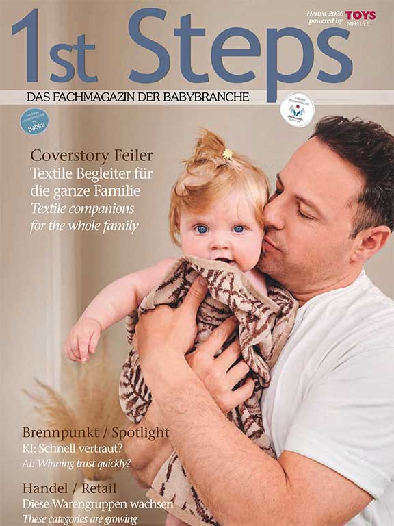 Zeitschriftencover zeigt Vater mit Baby auf dem Arm, das in Chenille Handtuch gewickelt ist.