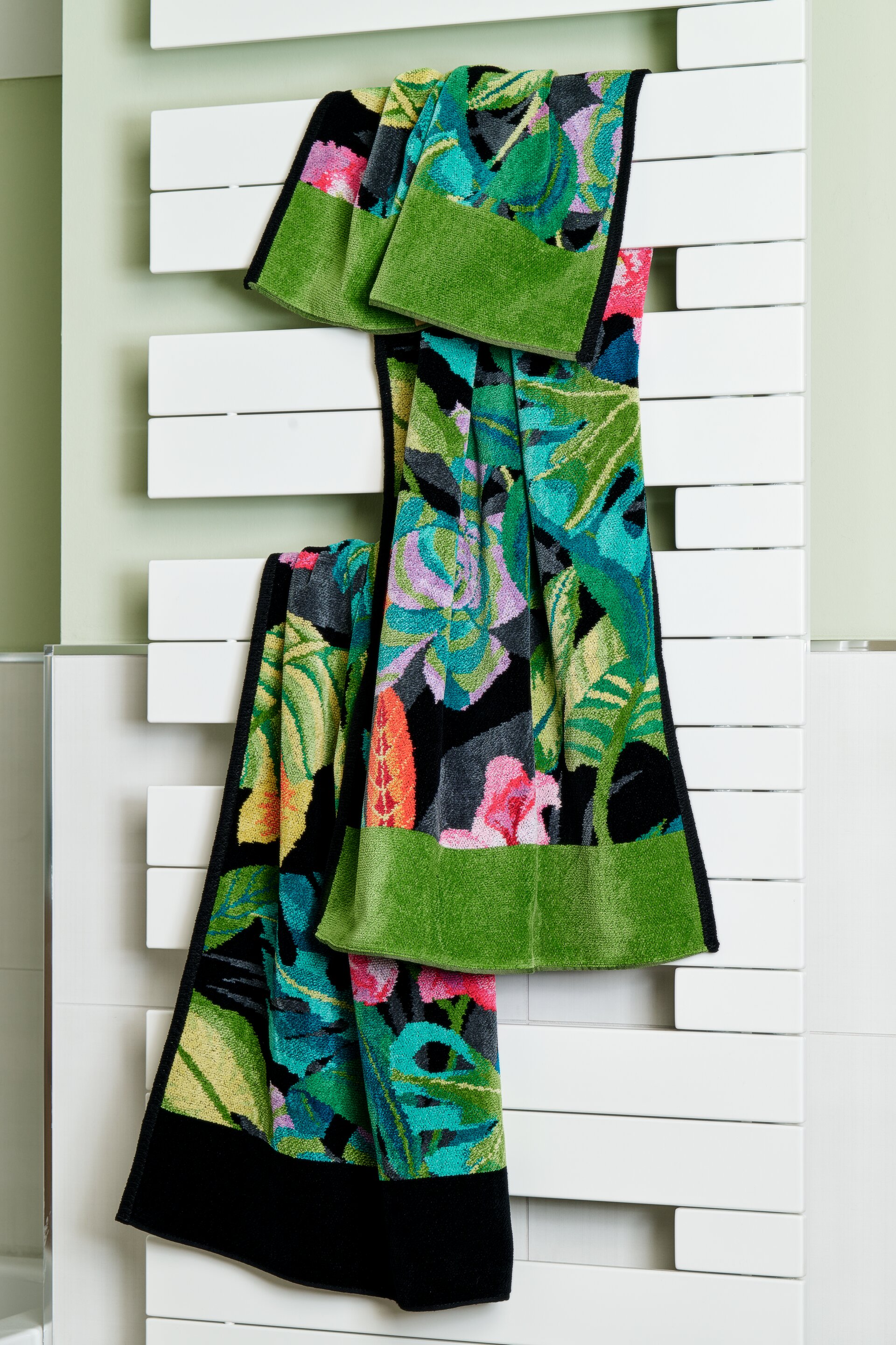 Smiling woman in bathroom with tropical towel