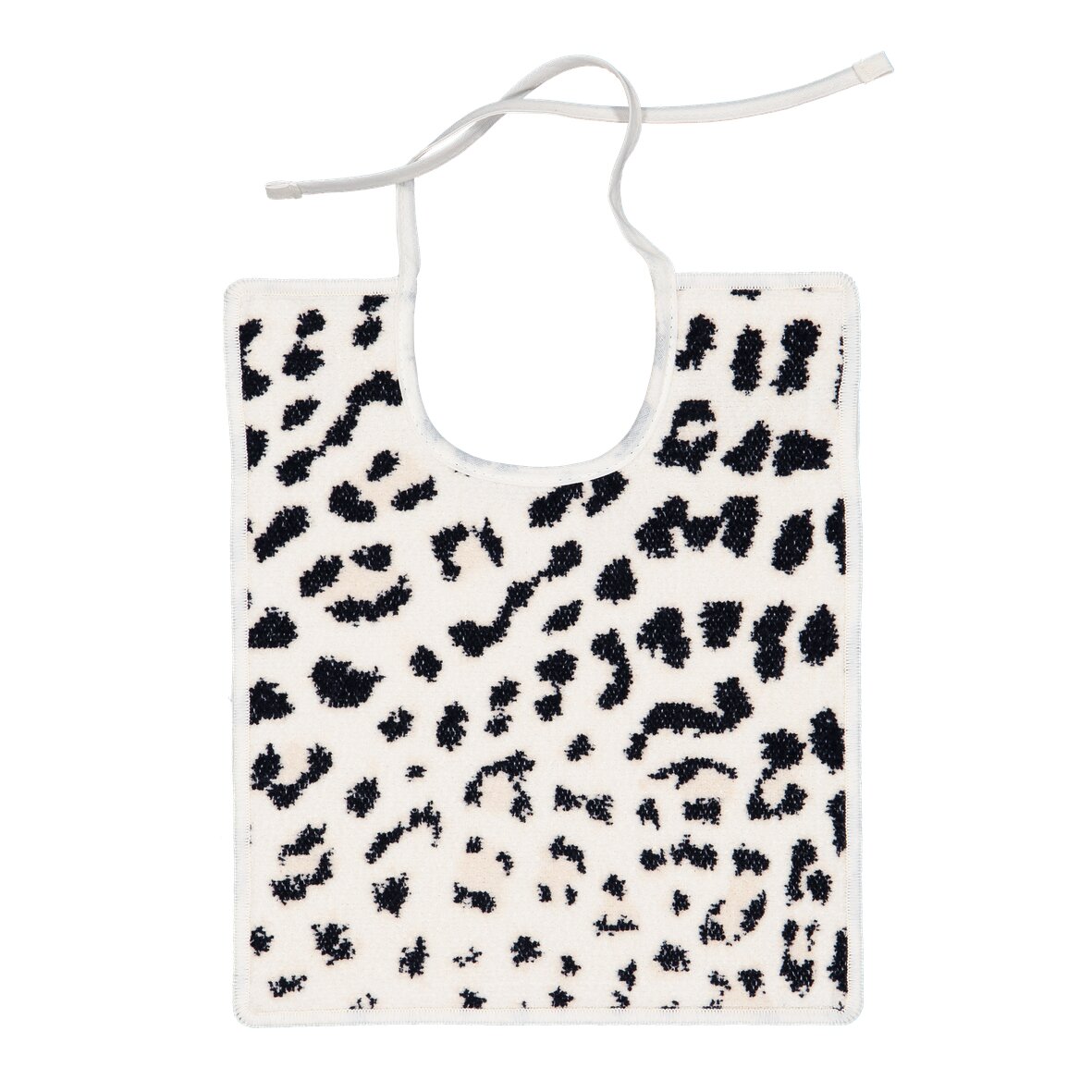White fabric with black, abstract spots. Soft chenille texture. Rectangular with a tie string on top.