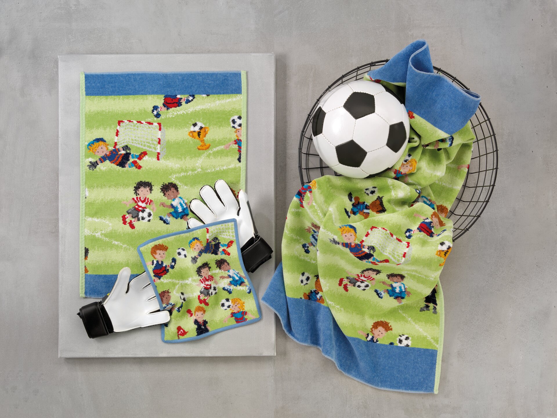 Green chenille textiles with playful football scenes and a blue border. Includes a football and gloves.