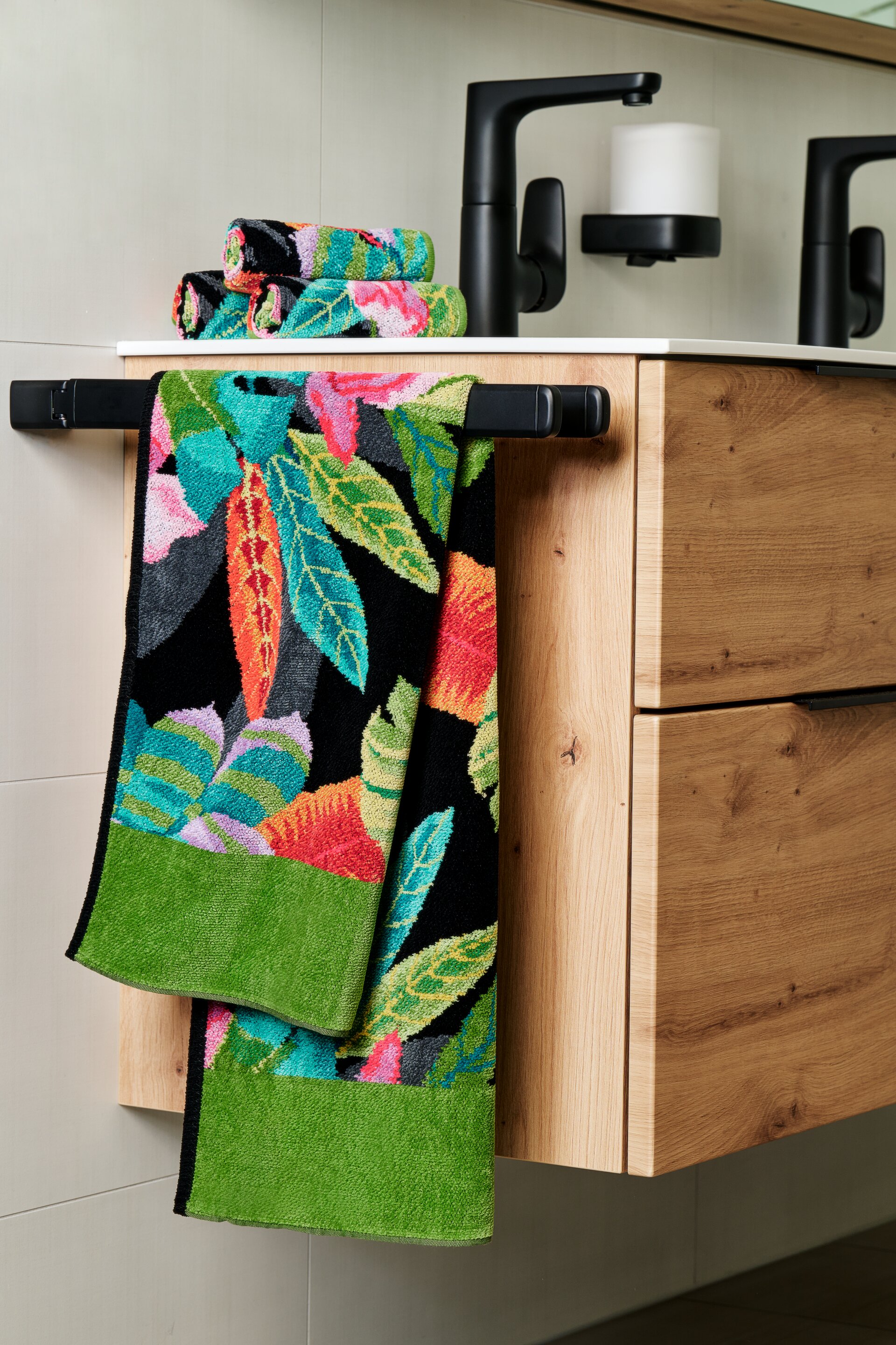 Tropical towel on towel rack in bathroom