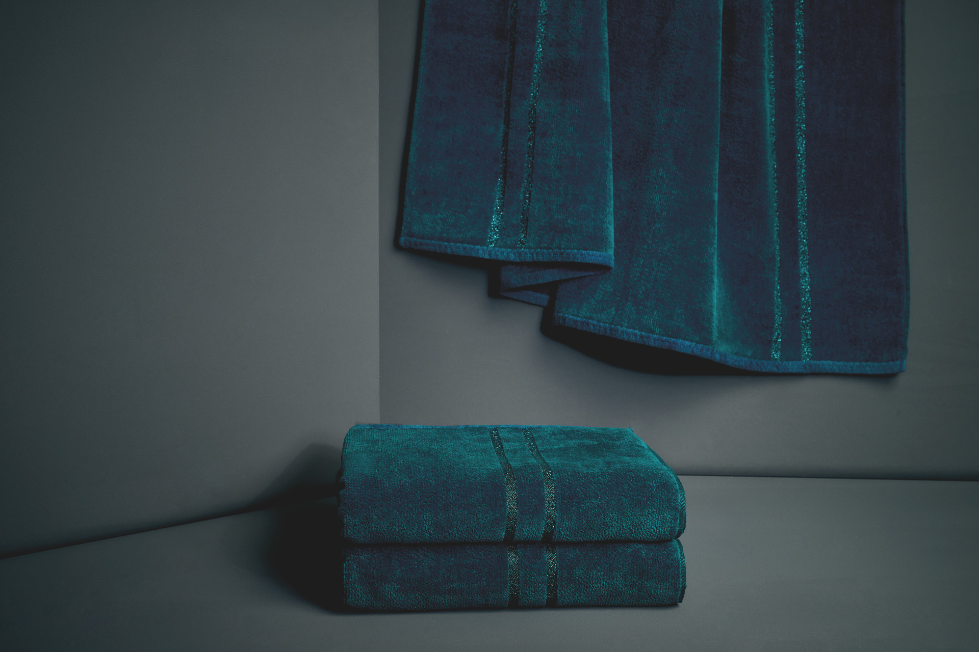 Luxurious teal fabric with a subtle striped pattern. Textured elegance for bathroom use.